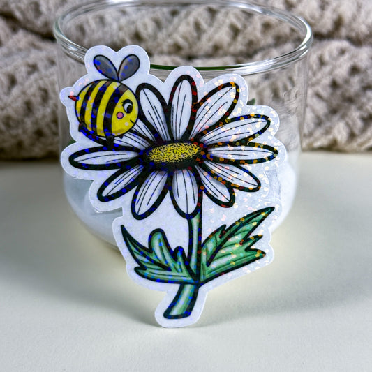 • Hand-drawn bee and daisy vinyl sticker in holographic finish, Kittlins • Bee & Daisy sticker in standard glossy finish on a white background showing clean die-cut edge • Kittlins floral bee sticker applied to a pastel planner cover