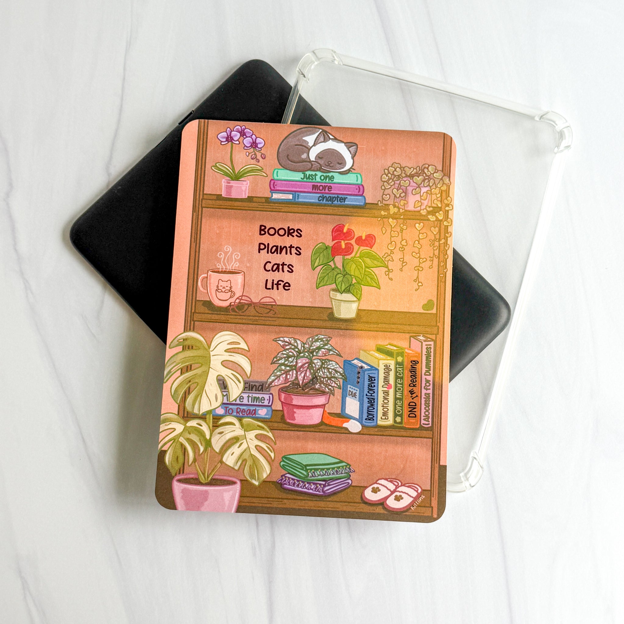 1. Books Plants Cats Life foiled Kindle insert with cozy bookshelf illustration, Kittlins
2. Kittlins cozy shelfie Kindle insert shown under a clear case (device and case not included)
3. Close-up of deep pink foiled Books Plants Cats Life text on cardstock Kindle insert